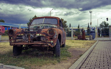 Old rusty car wreck. Old rusty passenger car at the junkyard. Car wreck, junkyard, scrap metal....