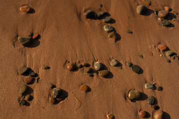 stones lie on sea sand during low tide wallpaper background