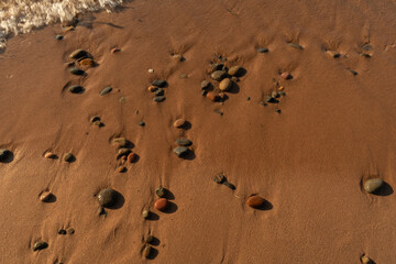 stones lie on sea sand during low tide wallpaper background