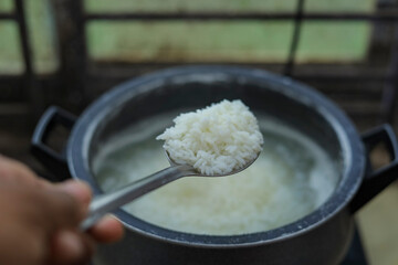 White Rice Cooking With Spoon Close up photo