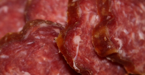 close up of salami. close up on salami slices. salami with selective focus. food details. traditional food.