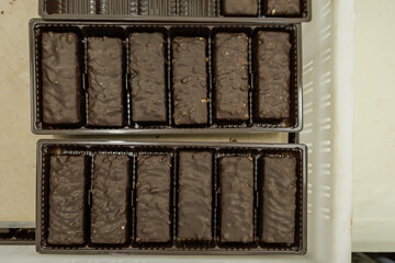 Top view of chocolate sweets in boxes.