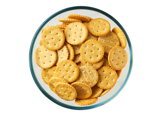 Round crackers in a clear glass bowl isolated on white background, top view.