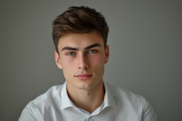 Obraz premium Portrait of a Young Man in a White Shirt