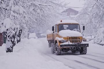 A snow plow clearing the streets, showcasing winter road maintenance and efficient snow removal.