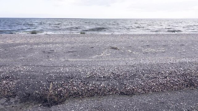 After the storm. The waves washed over the shore of spit and heaped up a sandbar