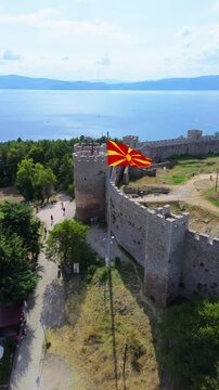 Delight in the scenic views of Ohrid's traditional homes, featuring their iconic red rooftops. This drone footage beautifully captures the essence of Macedonian culture.