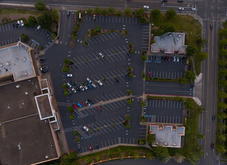 A parking lot with a lot of cars and a building in the background © Anton