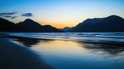 Fototapeta premium A serene sunset over a tranquil beach, with a silhouette of mountains and a reflection in the calm water.