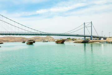 Traditional omani wooden dhow boats under Al Ayjah bridge, Sur, sultanate Oman