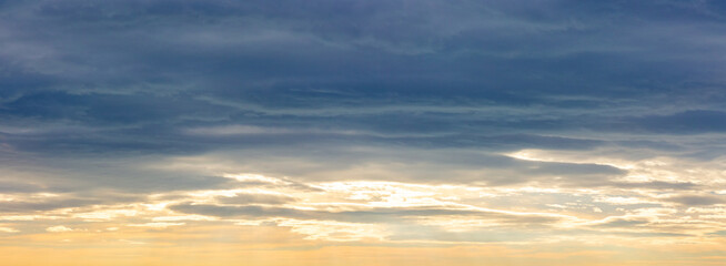 evening sky with dark blue clouds above after sunset