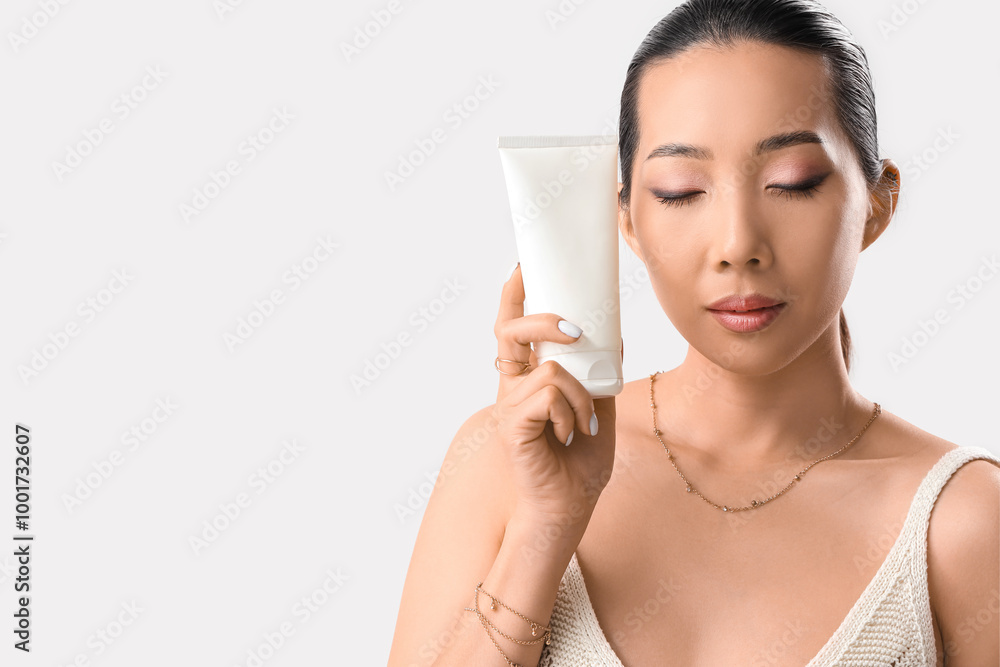 Canvas Prints beautiful asian woman with cosmetic cream on light background