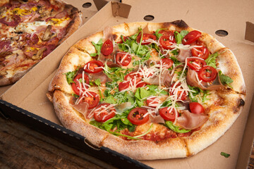 Whole pizza in a cardboard