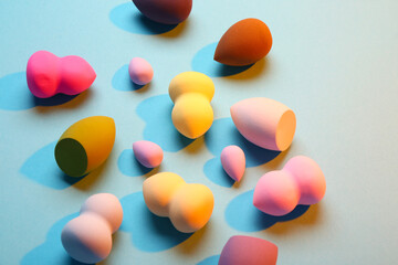 Different makeup sponges on blue background