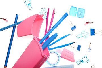 Flying pencil case with different stationery on white background