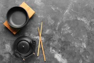 Chinese table setting with teapot on grunge background