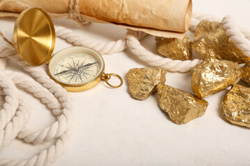 Travel equipment with scroll and golden nuggets on white background © Pixel-Shot