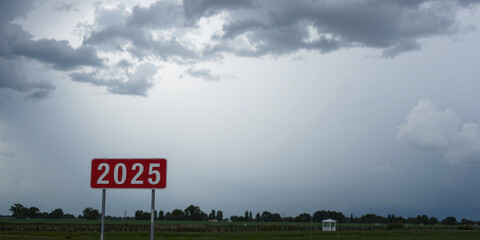 The lettering 2025 on or as a sign in front of a cloudy sky, future prospects for the coming year