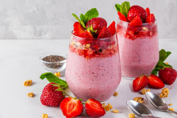 Healthy breakfast. Strawberry yogurt parfait with chia seeds topped with fresh strawberries,...