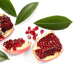 Pieces of fresh pomegranate and leaves on white background