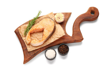 Wooden board of tasty fried salmon steak on white background