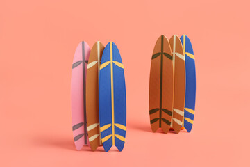 Different mini surfboards on pink background