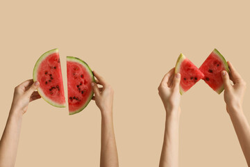 Female hands with slices of ripe watermelon on beige background