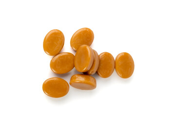 Caramel candies isolated, toffee caramel, round hard milk confectionery, brown sugar candies, small sweets