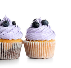 Tasty cupcakes with blueberries on white background