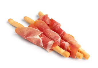 Tasty Italian Grissini with prosciutto on white background