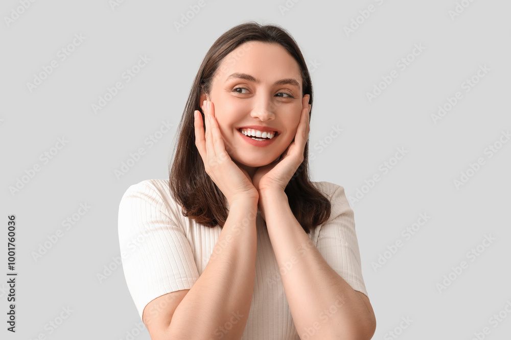 Sticker Smiling young woman on grey background