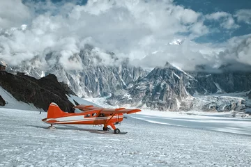 Selbstklebende Fototapeten Gletscher Red plane landing on a glacier in Denali mountains. Winter expedition.  © bonilook