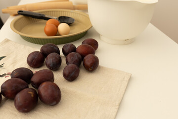 plum pie ingredients in plates, baking and cooking at home