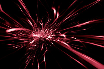 red  sparks from the grinder glowing in the dark