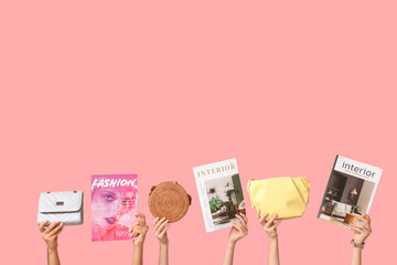Female hands with different magazines and stylish bags on pink background