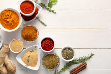 Composition with fresh aromatic spices and herbs on white wooden background