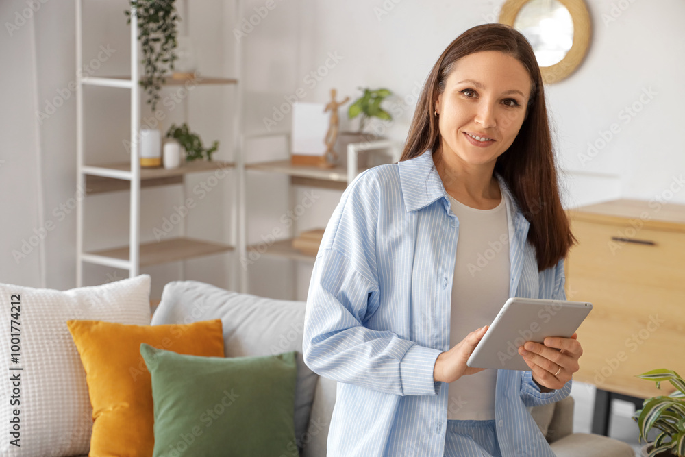 Canvas Prints Young woman using tablet computer at home