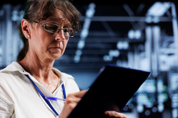 Octogenarian computer scientist inside high tech facility providing computing resources needed for...