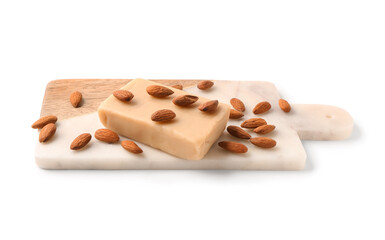 Cutting board with tasty marzipan bar and almond nuts on white background