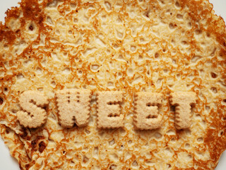 Sign sweet on a pancake or crepe. Popular simple multi national food known for its taste and flavoring options.