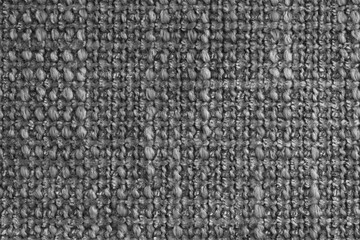 Texture of black jacquard fabric of rough weave, cloth structure background, close up, macro