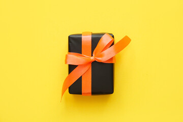 Halloween gift box on yellow background. Top view