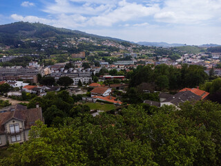 Fototapeta premium Aerial view of Guimaraes city, Castelo Guimaraes Castle and Paço dos Duques. Cityscape seen from the air. Portugal. Drone