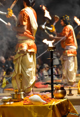 Pujaris or Indian priests performing Aarti ceremony on banks of Ganges in crowd