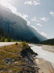 view of a small river in the mountains in summer with a little bit of smoke in the air 