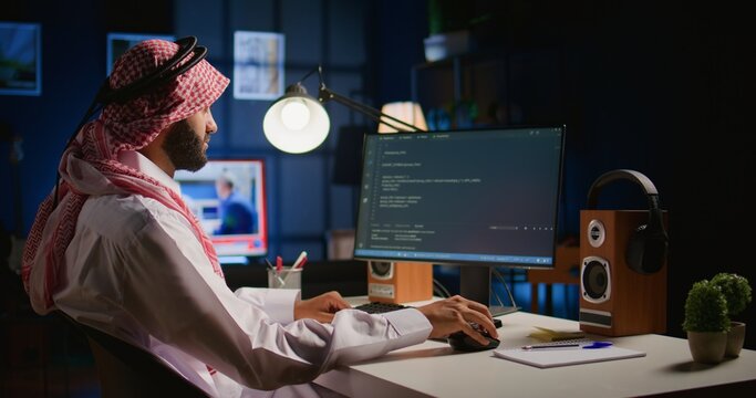 Technician writing script code on computer screen using Java programming languages for outsourced project. Teleworking employee at home fixing intranet database errors, handheld camera shot