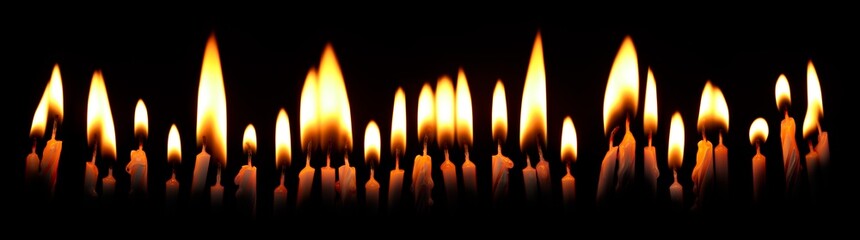 Row of brightly lit burning candles. Spooky glowing candles with burning flame for Halloween or other scary night backgrounds.