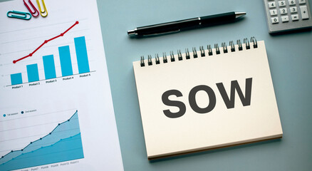 There is notebook with the word SOW. It is an abbreviation for Statement Of Work as eye-catching...