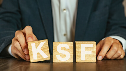 There is wood cube with the word KSF. It is an abbreviation for Key Success Factor as eye-catching...