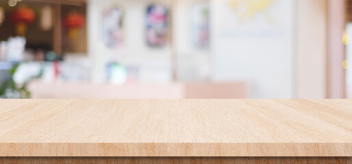 Table and blur restaurant background, Wooden counter cafe over blur bokeh background, Brown wood table top, shelf for food and retail shop, store food and product display banner, mockup, template